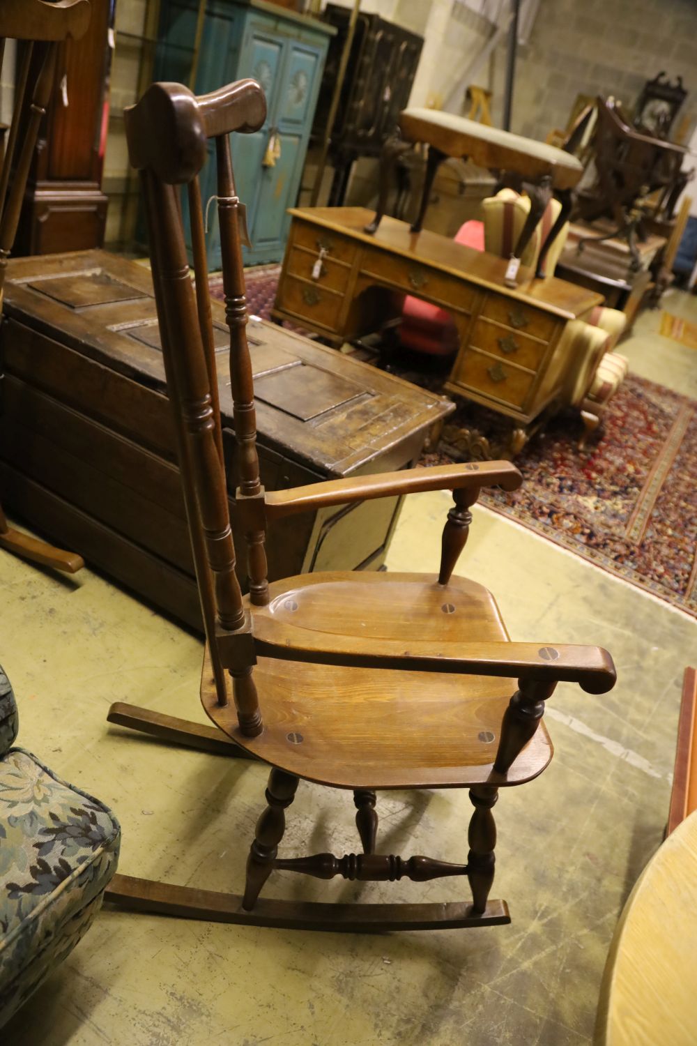 Two beech wood spindle back rocking armchairs, width 56cm, depth 55cm, height 128cm